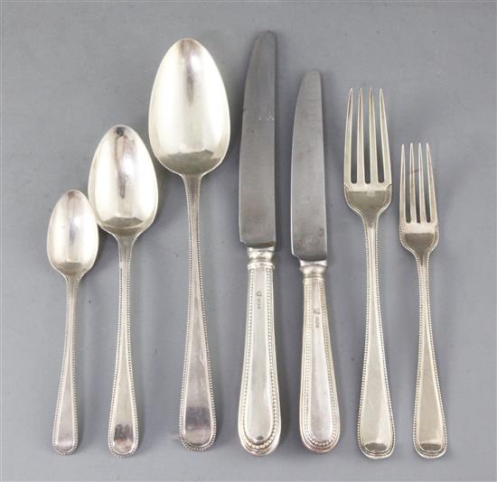 A part canteen of George III Old English beaded pattern flatware for twelve by Ely, Fearn & Chawner, weighable silver 75 oz.